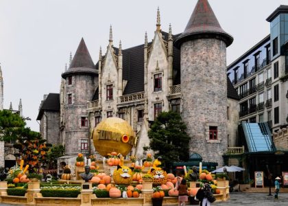 Charming castle with festive pumpkins at Ba Na Hills, Da Nang, Vietnam, perfect for a magical travel experience.