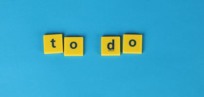 Yellow letter tiles spelling 'to do' against a vibrant blue background for organizational themes.