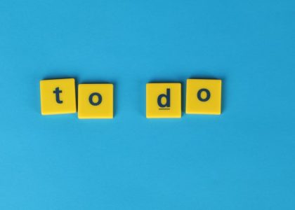 Yellow letter tiles spelling 'to do' against a vibrant blue background for organizational themes.
